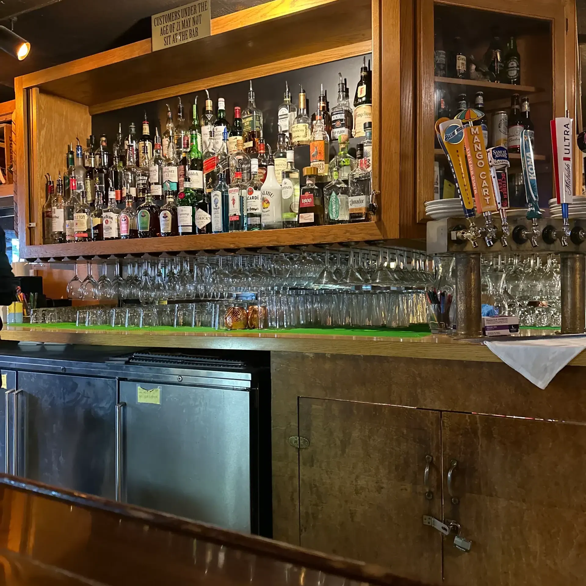 Bar with various liquor bottles and glasses at Rock Creek Restaurant in Twin Falls, ID.